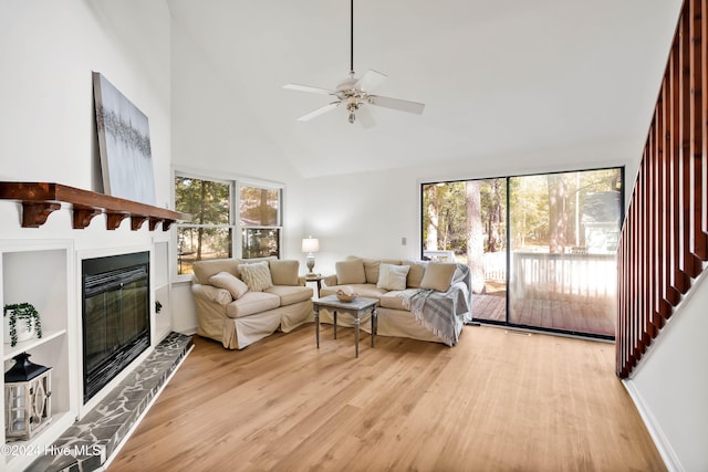 living room featuring high vaulted ceiling, light wood-type flooring, and ceiling fan