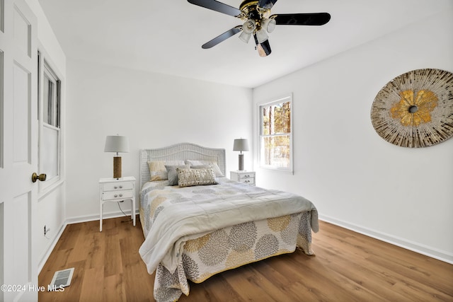 bedroom with hardwood / wood-style flooring and ceiling fan