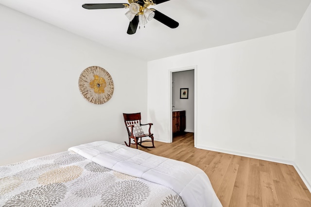 bedroom featuring ensuite bath, light hardwood / wood-style flooring, and ceiling fan