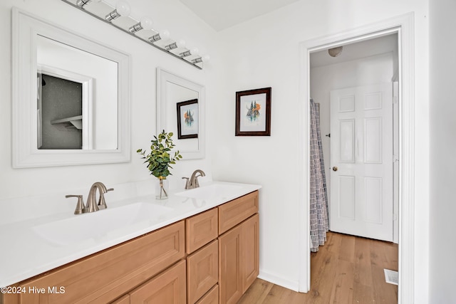 bathroom with vanity and wood-type flooring