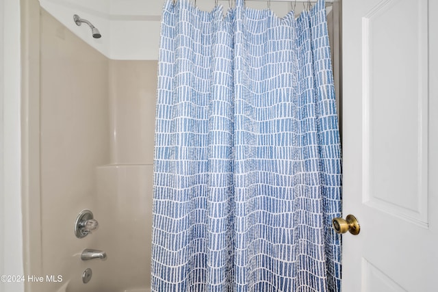 bathroom with shower / bath combo with shower curtain