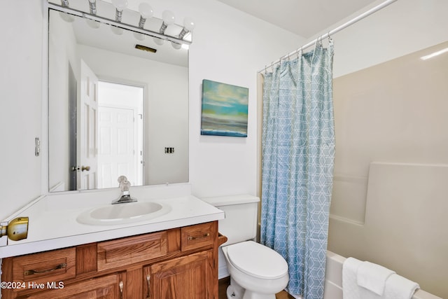 full bathroom with toilet, vanity, and shower / bath combination with curtain