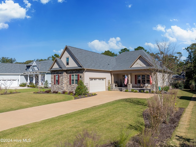 craftsman house with a front lawn and a garage