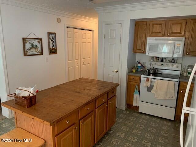 kitchen featuring crown molding, wood counters, and white appliances