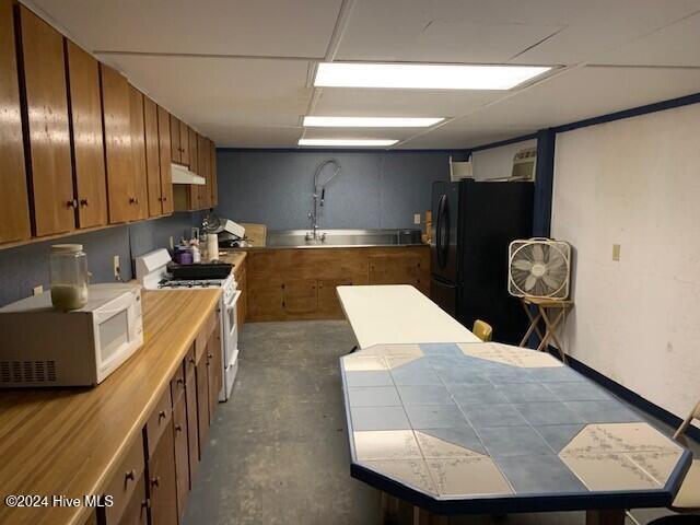 kitchen with tile counters and white appliances