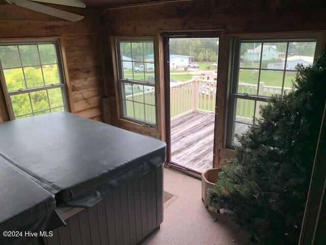 106 Summer Place Ln, Merry Hill, NC 27957 - doorway featuring wood walls, light colored carpet, and healthy amount of natural light