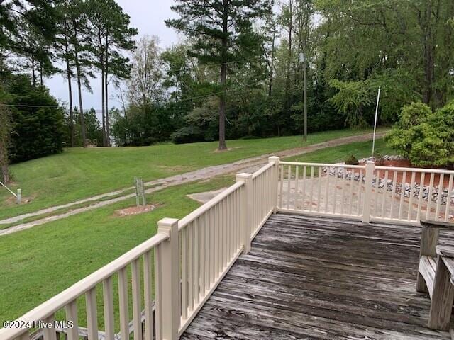 wooden deck featuring a yard