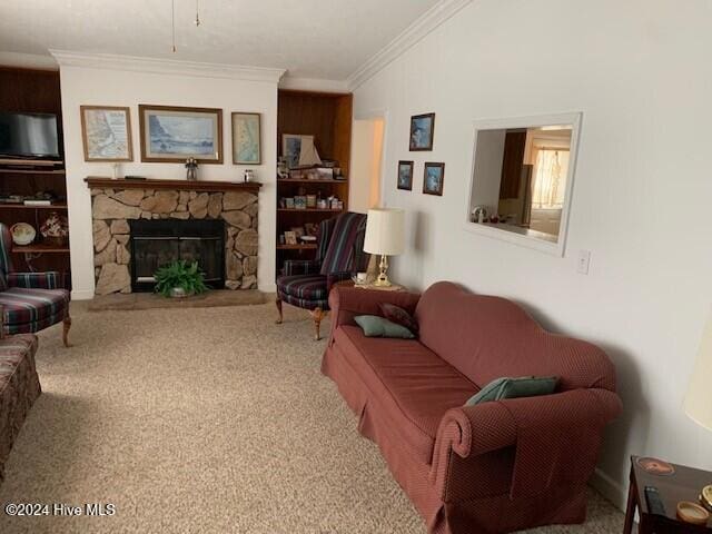 living room featuring crown molding, a stone fireplace, and carpet