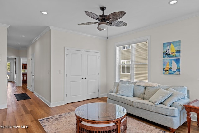 living room with ceiling fan, light hardwood / wood-style floors, and ornamental molding