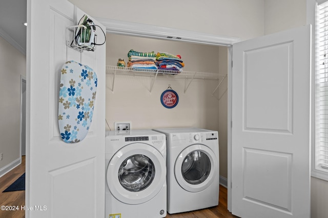 laundry area featuring wood-type flooring, independent washer and dryer, and ornamental molding