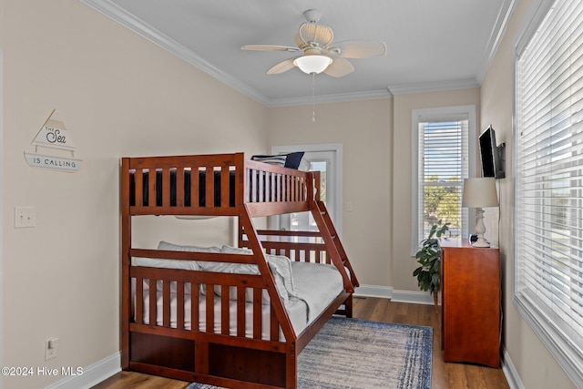 bedroom featuring ceiling fan, ornamental molding, multiple windows, and light hardwood / wood-style flooring