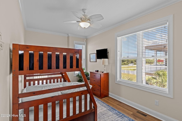 bedroom with ceiling fan, wood-type flooring, and ornamental molding