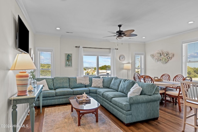 living room featuring a wealth of natural light, crown molding, ceiling fan, and wood-type flooring