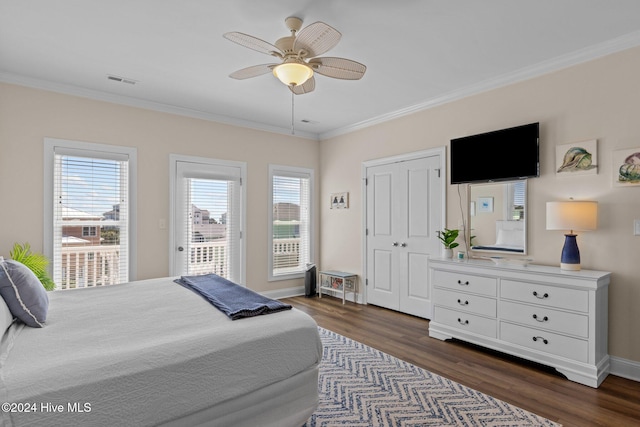 bedroom with dark hardwood / wood-style floors, ceiling fan, ornamental molding, and multiple windows