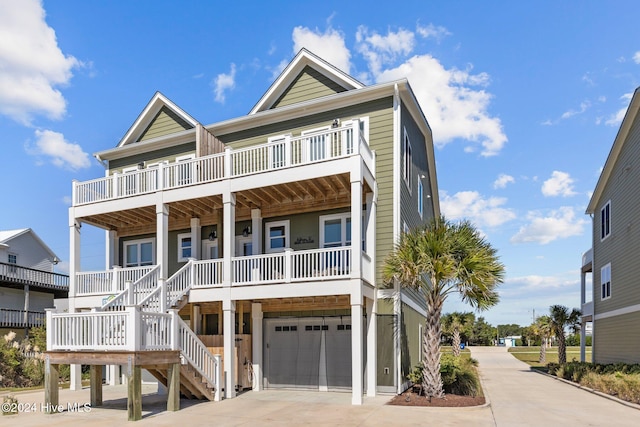 coastal inspired home featuring a porch and a garage