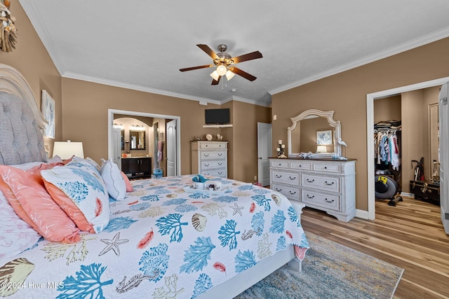 bedroom with a closet, ornamental molding, ensuite bathroom, light hardwood / wood-style floors, and ceiling fan