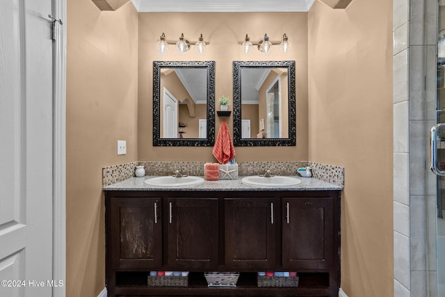 bathroom featuring vanity, ornamental molding, and a shower with door