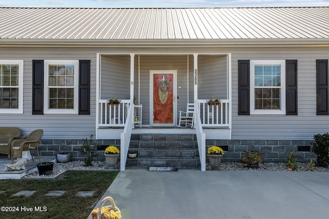 view of exterior entry featuring a porch