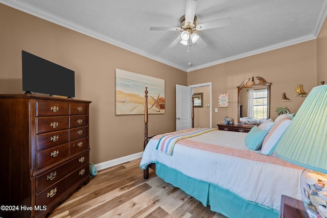 bedroom featuring ceiling fan, ornamental molding, a textured ceiling, and light wood-type flooring