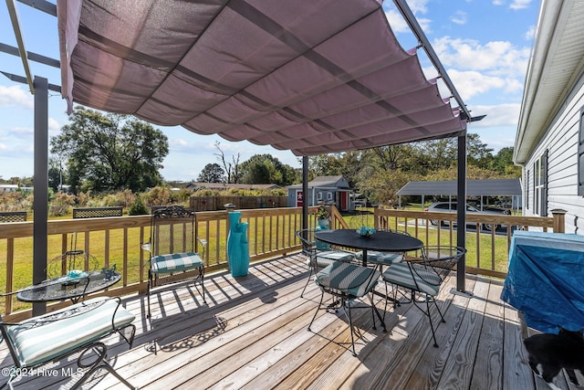 deck with a storage unit and a lawn