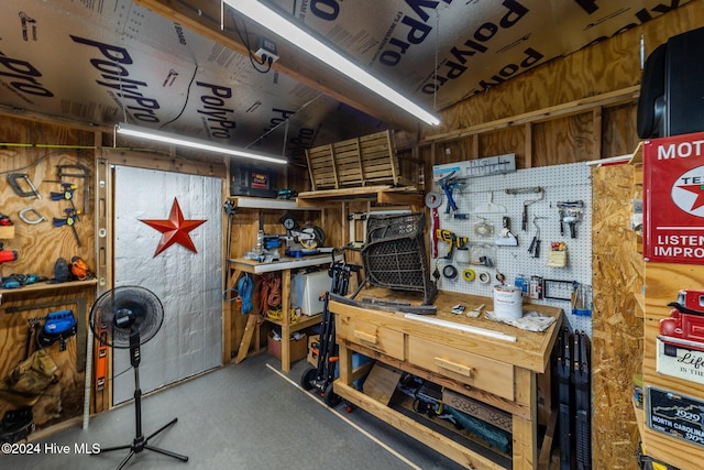 interior space with a workshop area and wood walls