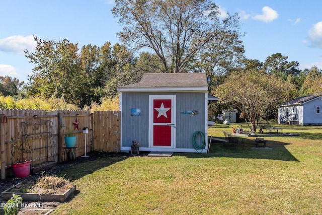 view of outdoor structure with a lawn