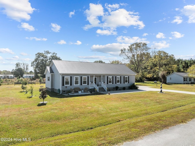 ranch-style house with a porch and a front lawn