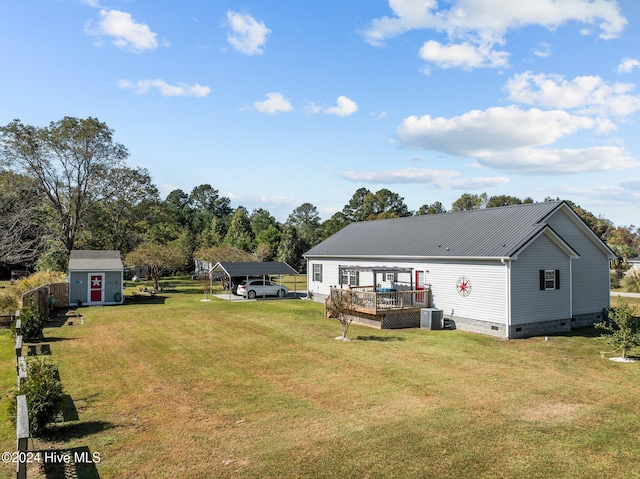 view of yard with a deck, a shed, and central AC unit