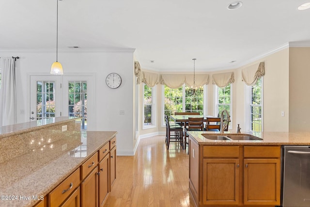 1109 Foxbow Cv, Leland, NC 28451 - kitchen featuring a sink, crown molding, brown cabinetry, dishwasher, and decorative light fixtures