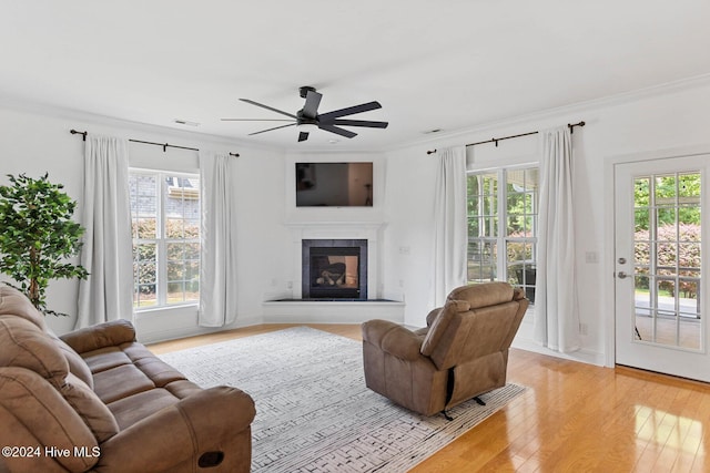 1109 Foxbow Cv, Leland, NC 28451 - living area with ceiling fan, ornamental molding, light wood finished floors, and a glass covered fireplace