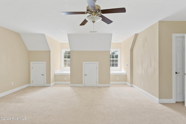 1109 Foxbow Cv, Leland, NC 28451 - unfurnished living room with light colored carpet, a ceiling fan, plenty of natural light, and lofted ceiling