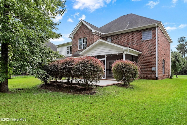 1109 Foxbow Cv, Leland, NC 28451 - back of property featuring a sunroom, brick siding, and a patio