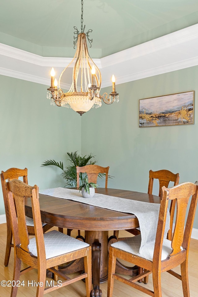 1109 Foxbow Cv, Leland, NC 28451 - dining room featuring a chandelier, light wood finished floors, ornamental molding, and baseboards