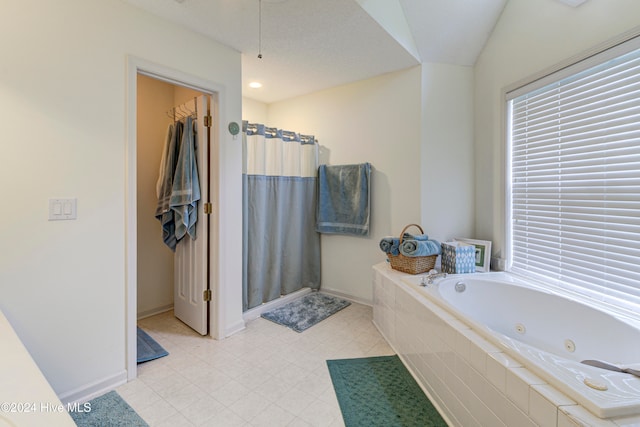 bathroom with independent shower and bath and a textured ceiling