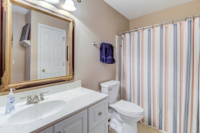 bathroom featuring vanity, toilet, a textured ceiling, and tile patterned flooring