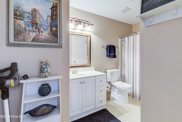 bathroom featuring vanity, a textured ceiling, and toilet