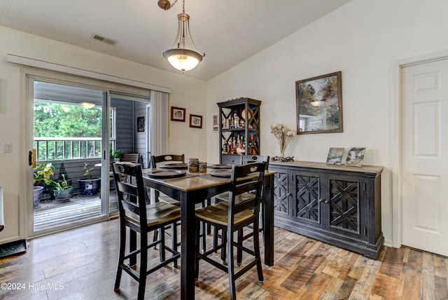 dining room featuring wood-type flooring and lofted ceiling