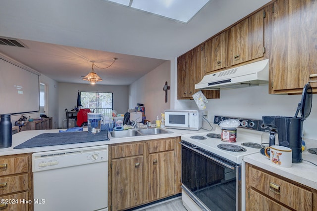 kitchen featuring pendant lighting, sink, and white appliances