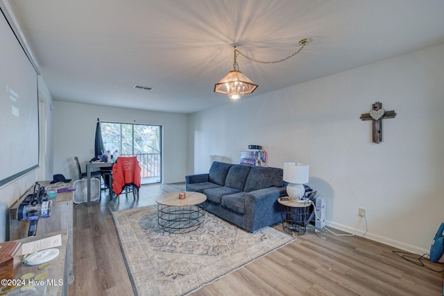 living room with a chandelier and hardwood / wood-style floors