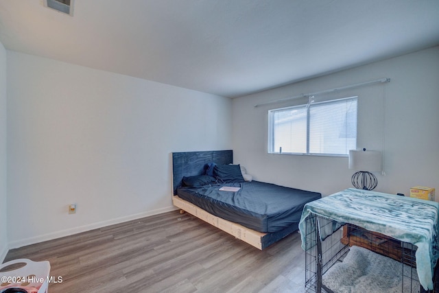 bedroom with hardwood / wood-style flooring