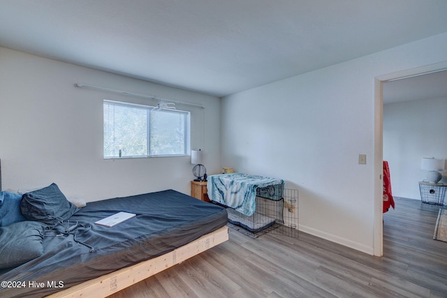 bedroom with hardwood / wood-style flooring