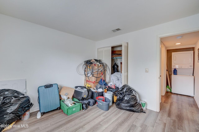 interior space with radiator heating unit and stacked washer / drying machine