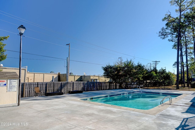 view of swimming pool with a patio area