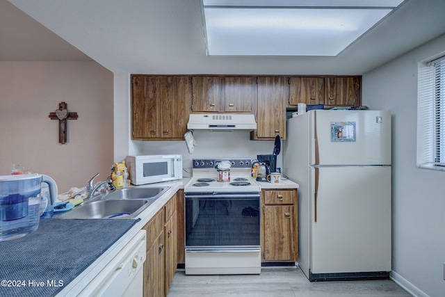 kitchen featuring light hardwood / wood-style floors, sink, and white appliances