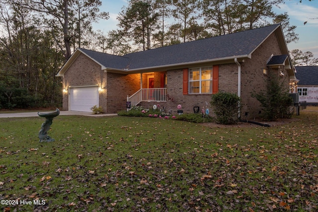 single story home featuring a lawn, a garage, and central air condition unit