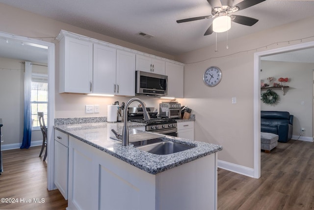 kitchen featuring white cabinets, a textured ceiling, and sink