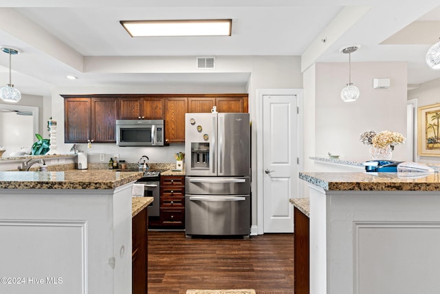 kitchen with pendant lighting, sink, dark hardwood / wood-style flooring, light stone counters, and stainless steel appliances