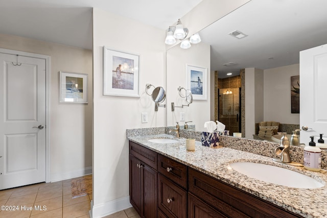 bathroom with tile patterned floors, vanity, and a shower with shower door