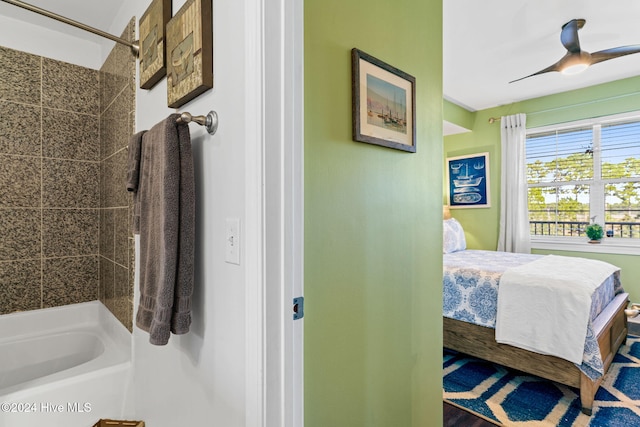 bathroom with ceiling fan and tiled shower / bath combo