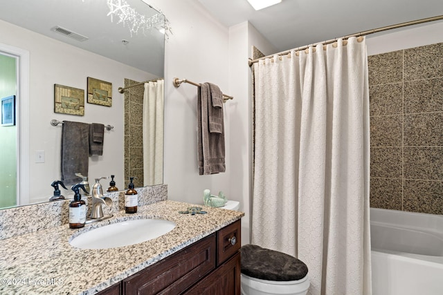 full bathroom featuring shower / bath combo with shower curtain, vanity, and toilet